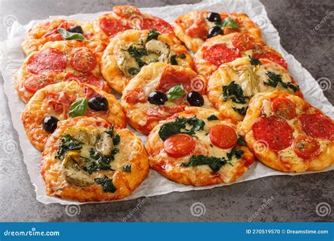 Italian Pizzette Mini Pizza Bites with Assorted Toppings Close-up on Parchment. Horizontal Stock ...