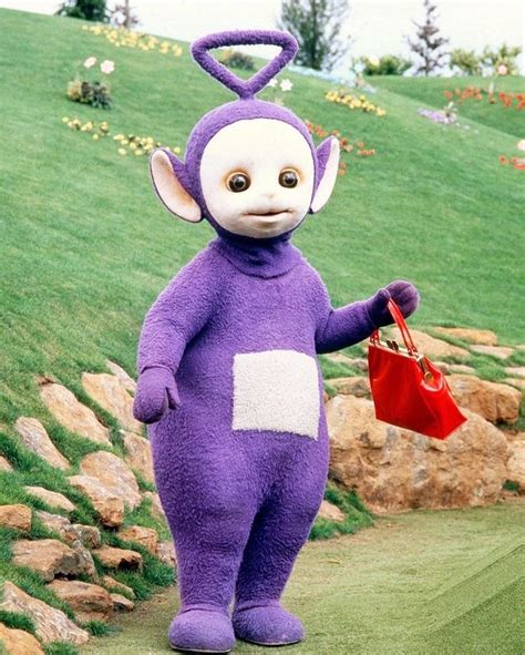 “Tinky Winky, the tallest Teletubby (10 feet/304cm), holding his red purse, 1999.” | Teletubbies ...