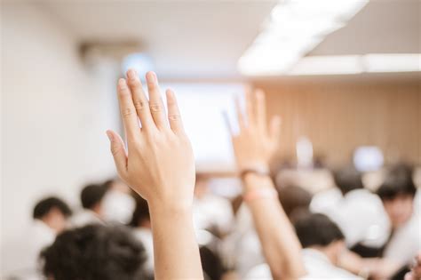 businessman raising hand during seminar. Businessman Raising Hand Up at a Conference to answer a ...