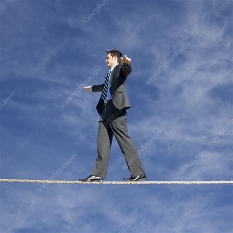 Businessman walking on tightrope - Stock Image - F006/4239 - Science Photo Library