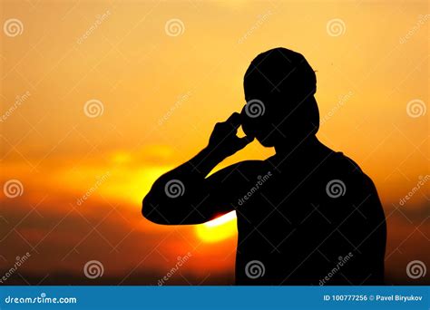 Silhouette of Young Man Using His Mobile Phone Stock Photo - Image of ...