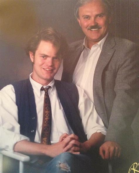 two men sitting next to each other wearing ties