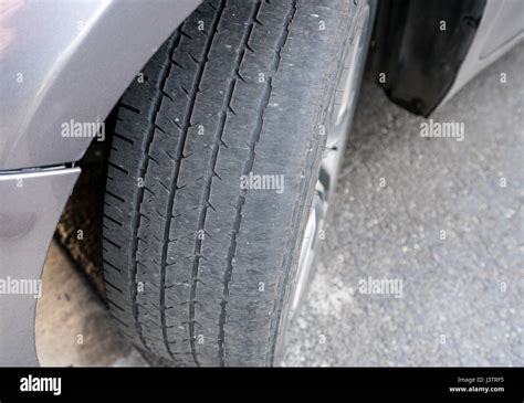 Bald front wheel tires on vehicle needing replacement Stock Photo - Alamy