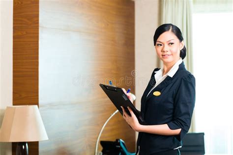 Asian Executive Housekeeper Controlling Hotel Room Stock Image - Image ...