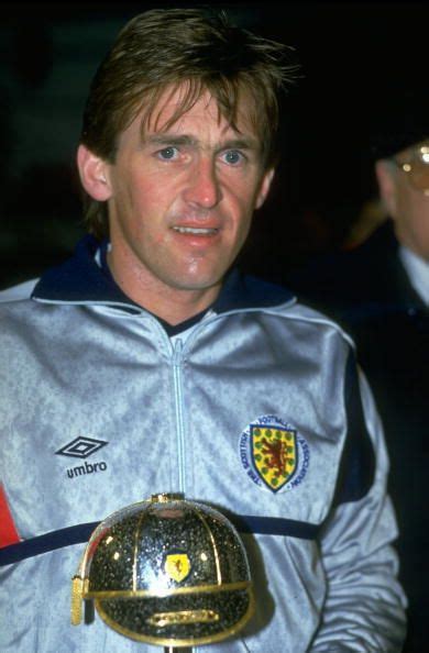 Portrait of Kenny Dalglish of Scotland holding his award for achieving ...