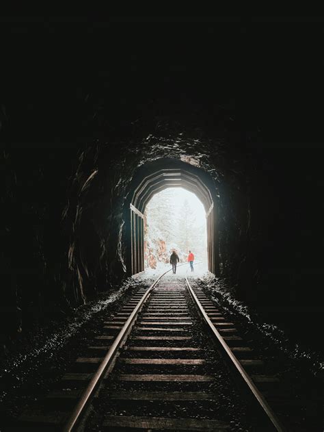 Railroad in dark tunnel in winter · Free Stock Photo