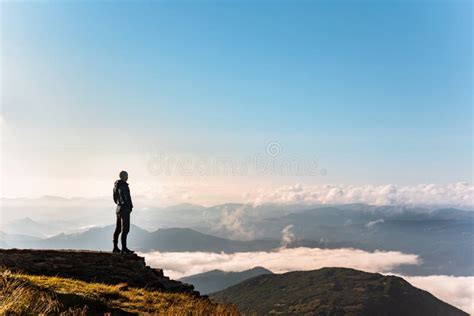 Man Standing at the Edge of the Cliff Looking at Mountains Stock Image ...