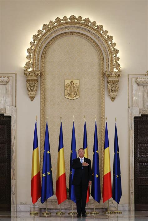 Romanian President Klaus Iohannis stands while listening the national anthem at Cotroceni Palace ...