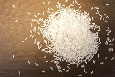 Raw White Rice Scattered on the Table Photo Closeup Stock Photo - Image ...