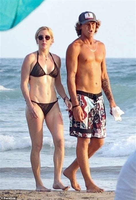 Ellie Goulding's romance with hunky surfing instructor heats up! Singer looks cosy with Armando ...