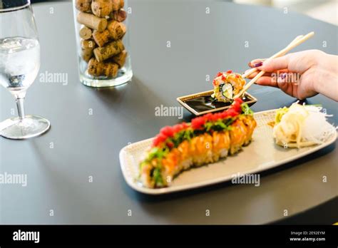 Woman eating sushi at a restaurant Stock Photo - Alamy