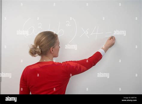 Teacher writing on whiteboard Stock Photo - Alamy