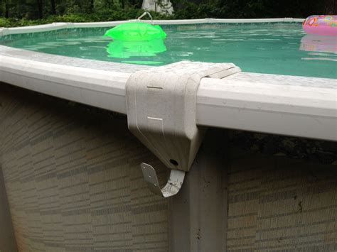 Pool vacuum hose holder using lumber straps spray painted white ...