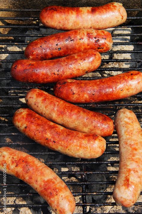 Bratwursts on a grill. Close up composition of grilled outdoor brat ...