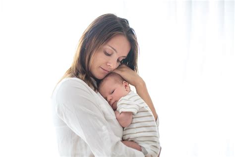 Young mother, holding her newborn baby boy - MGH Center for Women's Mental Health