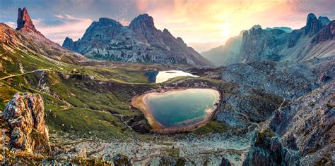 Impressive summer sunrise in rocky mountain valley. Fantastic morning scene of Tre Cime di ...