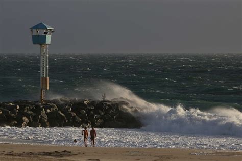 Perth storm hits with force as fierce cold front cuts power to 55,000 homes in WA's south-west ...