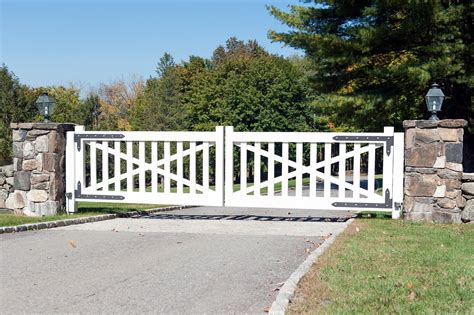 Streamlined farmhouse design for this white wooden driveway gate ...