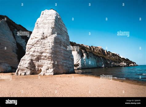 Beautiful view of The Pizzomunno, a large white rock monolith in Spiaggia di Castello Beach in ...