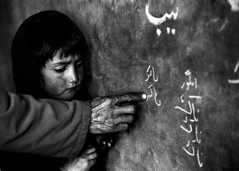 A girl stands at the blackboard in a classroom in the Central Asia Institute School, founded by ...