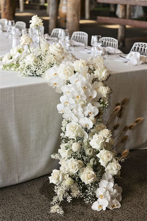Modern White Wedding Style with Babies Breath, Phalaenopsis Orchids, Roses and Dried Flowerin ...