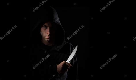 Dangerous hooded man holding knife Stock Photo by ©ijdema 29920419