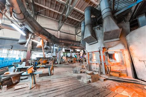 Premium Photo | Glass factory workers on production of glass with manufacture equipment