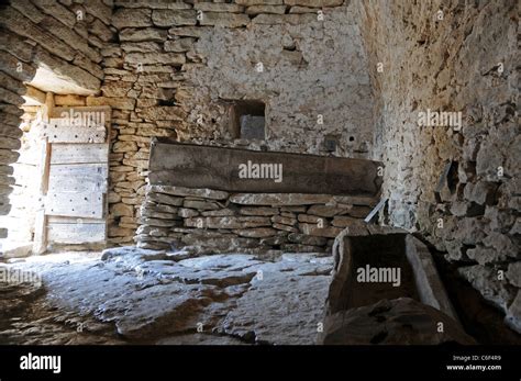 Interior of ancient byre with manger made from stones in The Bories ...