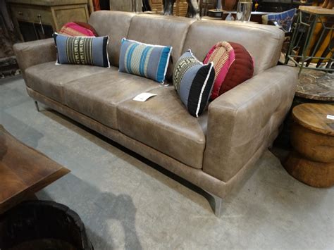 Elegant Beige Faux Leather Sofa Couch has a modern feel.