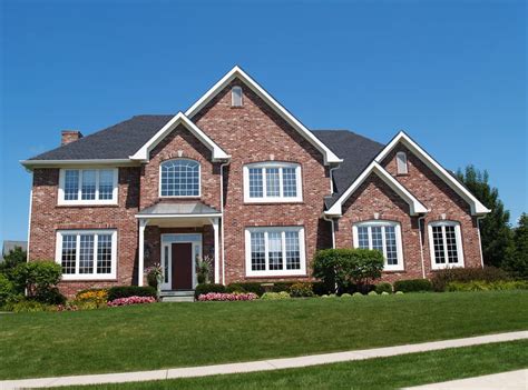 New suburban house with the entire front facade being red brick contrasted nicely with white ...