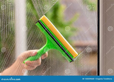 Window Cleaner Using a Squeegee To Wash a Window Stock Photo - Image of wipe, clean: 143039668