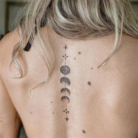 Fine line moon phases tattoo on the back.