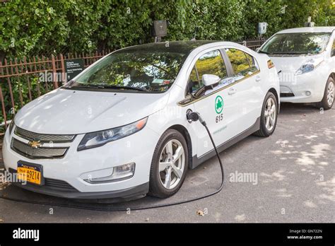 A New York City Parks department Chevy Volt electric car receives a charge at a charging station ...