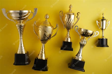 Premium Photo | Gold trophy against yellow background