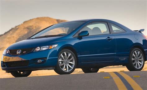 a blue honda civic is parked on the side of the road with mountains in ...