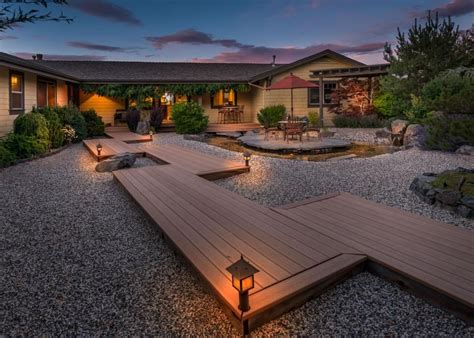 This yellow ranch home boasts a backyard with a staggered deck walkway ...