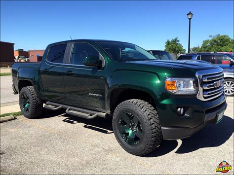 2016 GMC Canyon with a leveling kit, ST Maxx tires and custom green ...