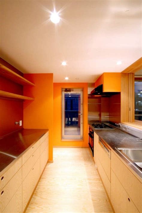 Orange walls, wood cabinets and stainless countertops Stainless Steel Kitchen Countertops ...