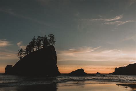 Silhouette of Rock Formation on Sea during Sunset · Free Stock Photo