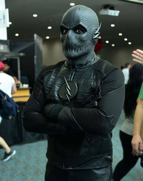 a man in a black leather outfit with his arms crossed