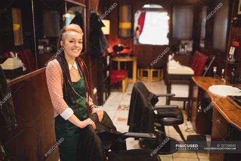 Portrait of smiling female barber standing in barber shop — industry, owner - Stock Photo ...