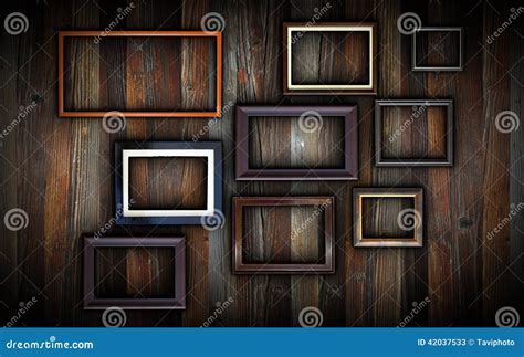 Frames on dark wooden wall stock image. Image of obsolete - 42037533