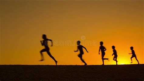 Silhouette of Five Kids Running Against Sunset Stock Video - Video of ...