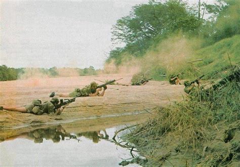 Soldiers from the Rhodesian Light Infantry (RLI), firing their FN FAL battle rifles during a ...