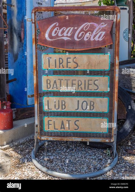 Antique metal gas station sign advertising for Coca-Cola and tires, batteries, lub job, and ...