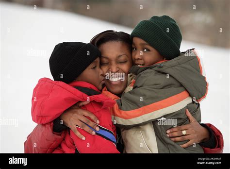 Mother hugging her children Stock Photo - Alamy