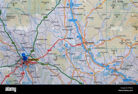 Road map of the Dumfries area of Scotland, showing the surrounding roads and with a map pin in ...