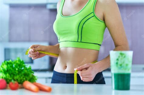 Premium Photo | Diet woman in sportswear with measuring tape and a ...