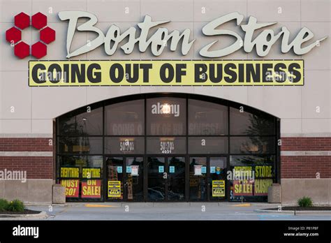 A logo sign and 'Going Out Of Business' banner outside of a Boston ...