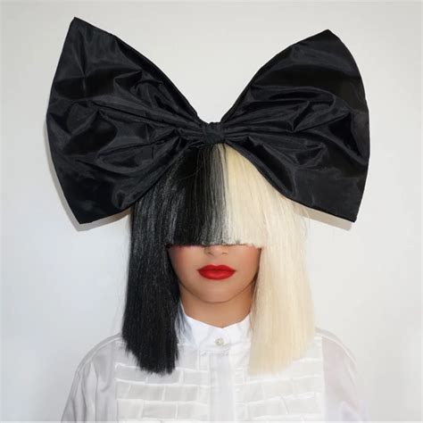 a mannequin wearing a black and white wig with a large bow on it's head